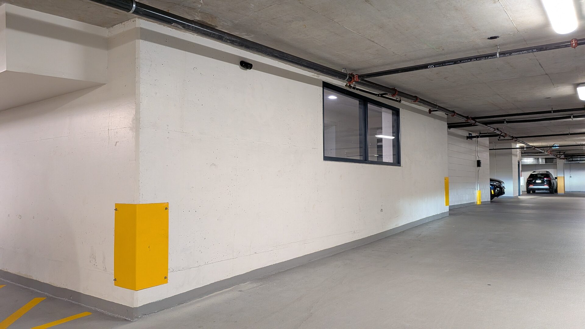 Parkade drive aisle covered by a wall-mounted camera